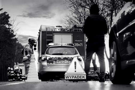 Emergency services at the car crash scene in black and white