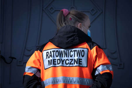 Beautiful blonde female paramedic in a uniform reading "Emergency Medical Service" in Polish ("Ratownictwo Medyczne")のeditorial素材