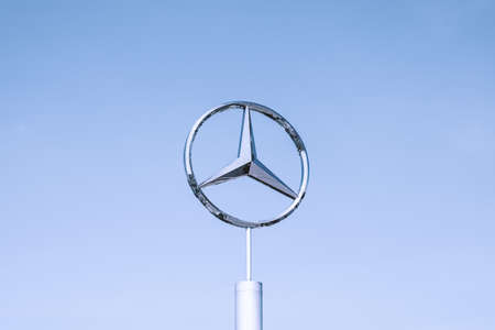 Mercedes-Benz logo with a blue sky background