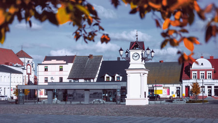 Lwowek, Wielkopolskie, Poland - the main square with a clock tower and a bus station in colorful autumn scenery.のeditorial素材