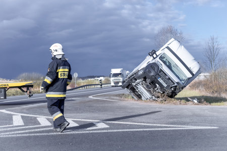Firefighters and rescue services lifting an overturned van at the site of a car crash.のeditorial素材