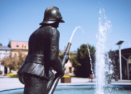 Rakoniewice, Poland - a fountain with a firefighter statue, one of the symbols of the city.のeditorial素材