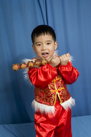 children holding a candied gourdの写真素材