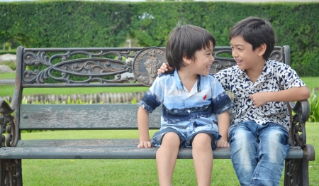 Asian Little sibling laughingの写真素材