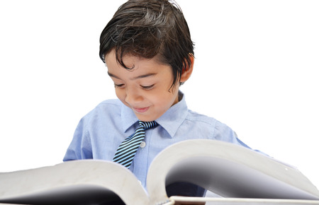 Little boy reading a book on white の写真素材
