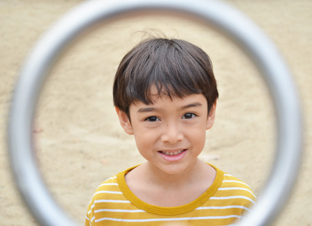 Little boy smiling at playground face on cycle