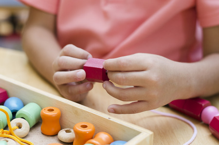 Little boy with Montessori material colored beads の写真素材