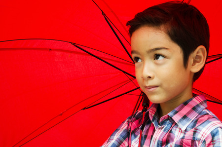 Little boy taking an umbrellaの写真素材