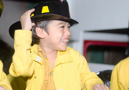 Little Firefighters fighting fire during trainingの写真素材