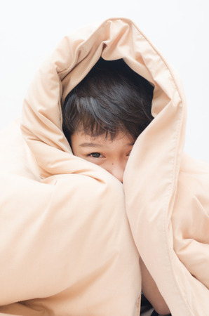 Little boy under blanketの写真素材