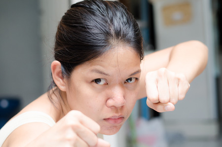 Asian woman ready to fight guading with empty handの写真素材
