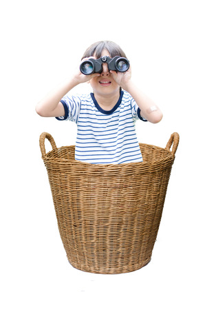 Little boy with binoculas in the Basket on white backgroundの写真素材
