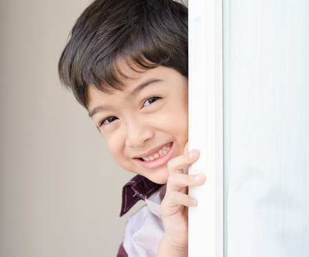 Little boy opening the door curtainの写真素材