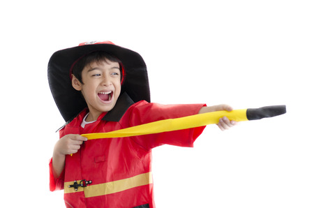 Little boy pretend as a fire fighter on white backgroundの写真素材