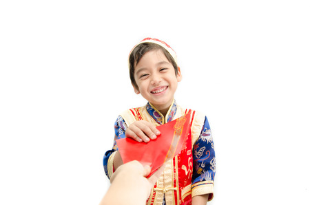 Little boy in dress for chinese with present new year on white backgroundの写真素材