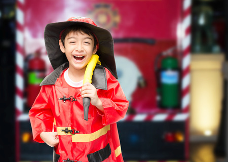 Little boy pretend as a fire fighterの写真素材
