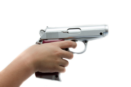 Kid's hand taking gun on white background