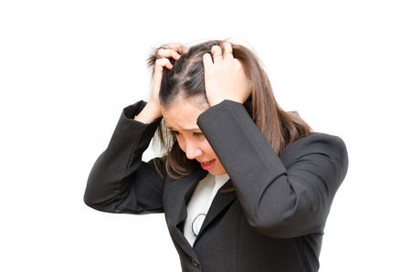 Asian business woman holding hair with stress face on white backgroundの写真素材