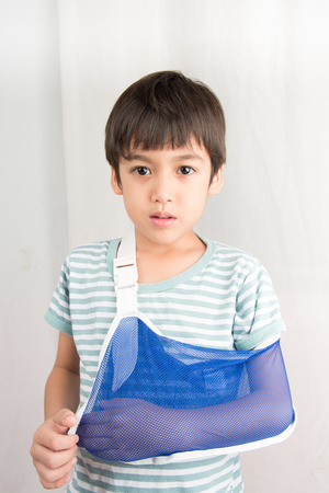 Little boy arm broken using arm slingの写真素材