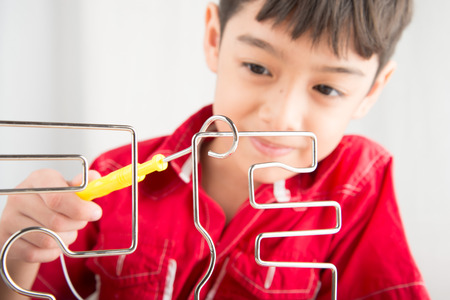 Little boy playing coil spark with concentrate close up
