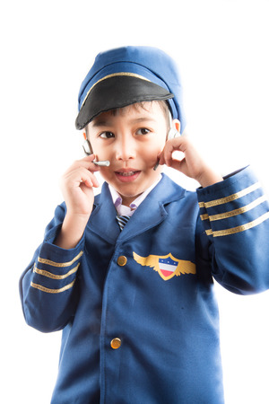 Little boy pretend as a pilot on white backgroundの写真素材