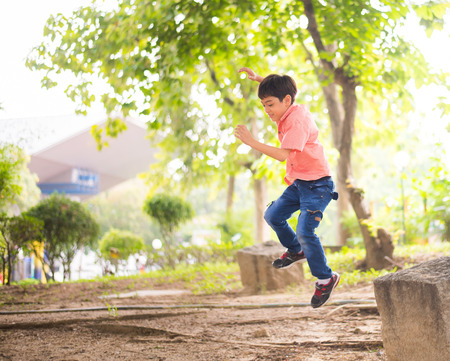 Little boy jumping in the parkの写真素材