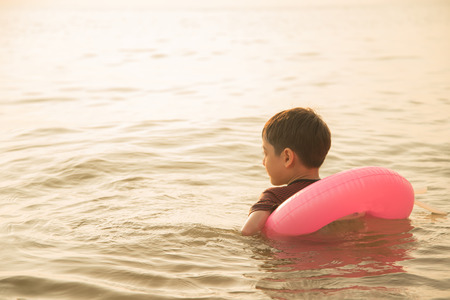 Little boy swimming on the beachの写真素材