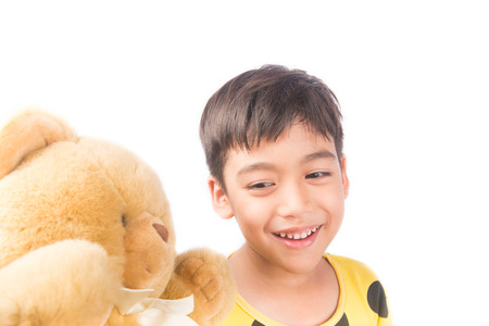 Little boy hugging bear wearing pijamasの写真素材
