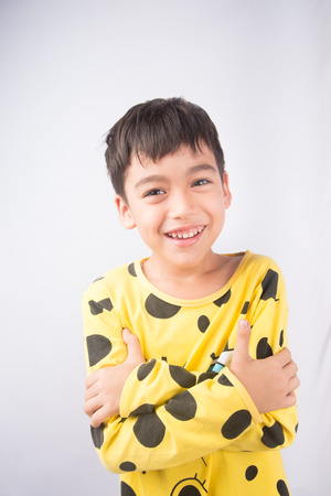 Little boy hugging himself on pijamasの写真素材