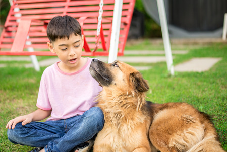 Little boy sitting with dog friendshipの写真素材