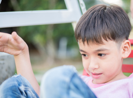 Little boy playing sitting in the parkの写真素材