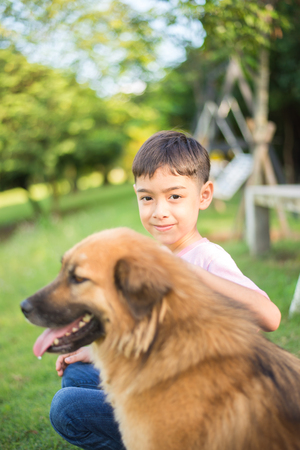 Little boy sitting with dog friendshipの写真素材