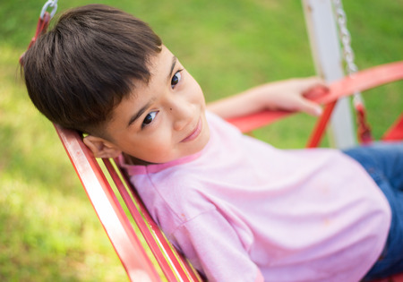 Little boy sitting in the parkの写真素材