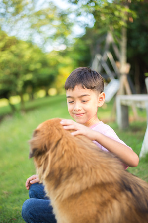 Little boy sitting with dog friendshipの写真素材