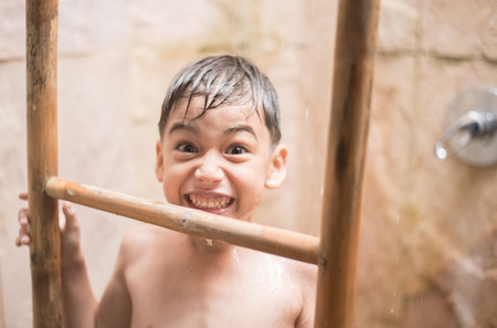 Little boy taking shower