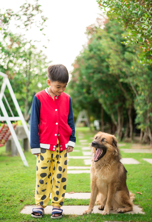 Little boy sitting with dog friendshipの写真素材