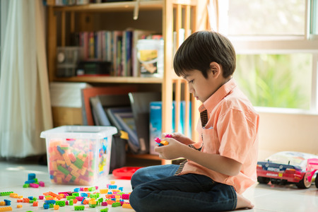 Little boy playing block indoor house educationの写真素材