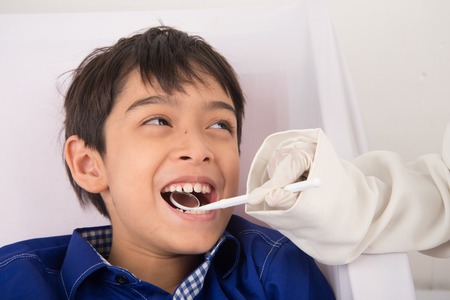 Little sibling boy pretend as a dentist vLittle sibling boy pretend as a dentist close up inside...