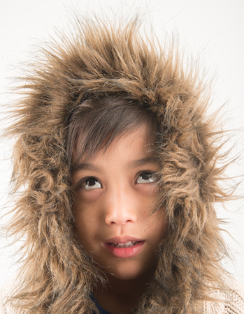 Little boy wearing fur coat protect from coldの写真素材