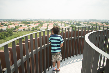 Boy walking on the wood bridgeの写真素材