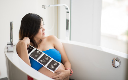 Pregnancy belly skin close up sitting in bahtの写真素材