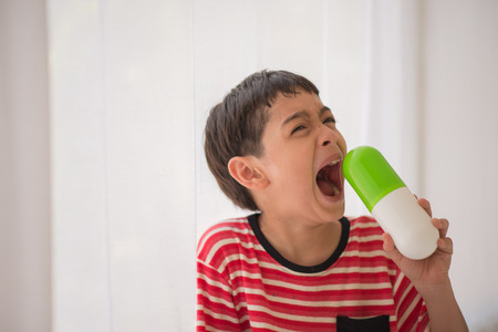 Little boy taking medicine drug