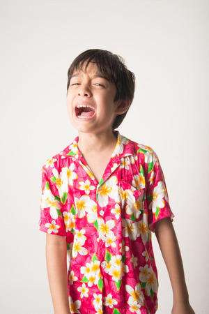 Little boy laughing portrait standing angry faceの写真素材