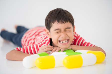 Little boy taking medicine drugの写真素材