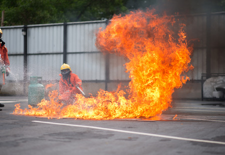 Firefighter fighting fire during trainingの写真素材
