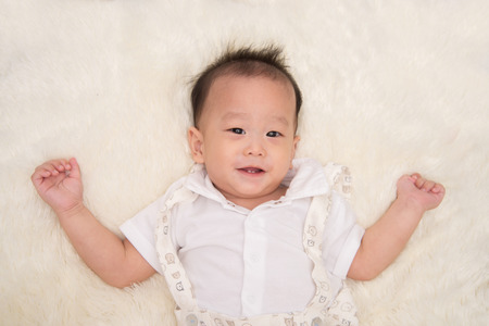 Little asian baby boy smiling with happy face