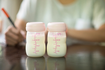 Mother writing breastfeeding stock for babyの写真素材