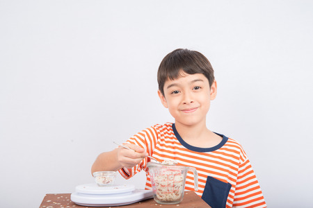 Little boy leaning weight scale education in classの写真素材
