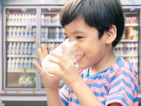 Little boy drinking fresh milk for healthy background of UHT milk storageの写真素材