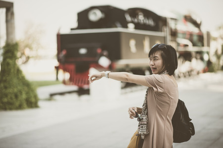 Asian woman waiting for train coming fortravel transportation vintage styleの写真素材